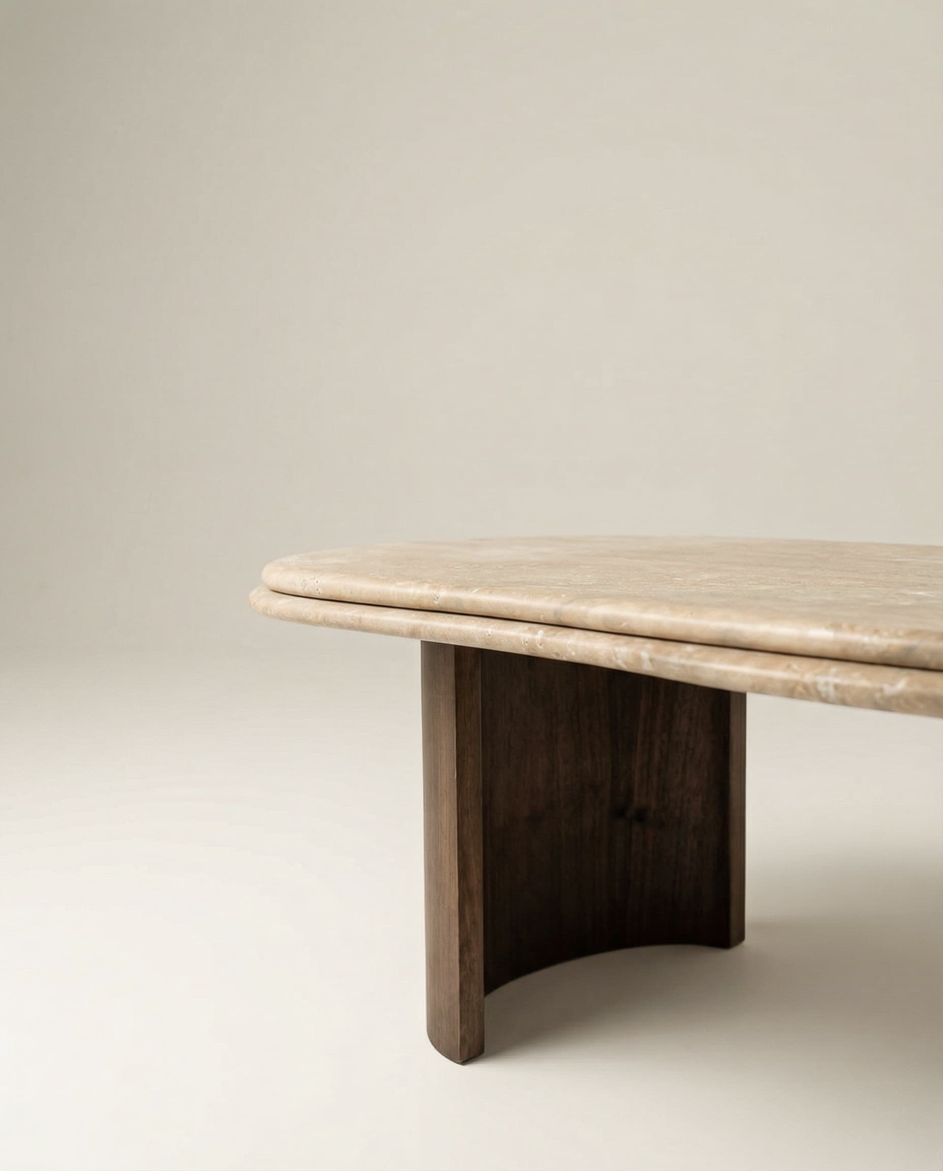 Marble coffee table with a double beige travertine top and dark brown solid ash wood legs on a plain background